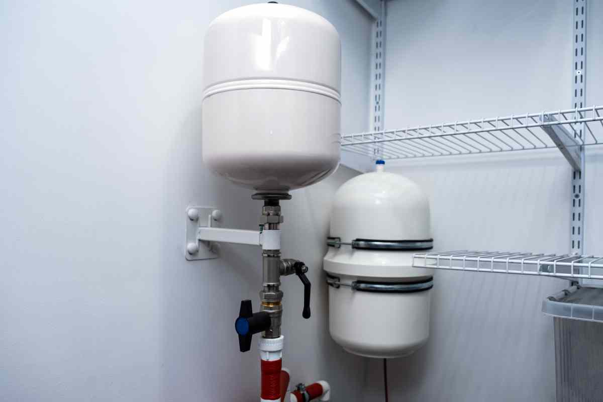 Residential well water treatment system with tanks, pipes, and valves